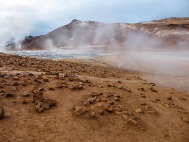 Smoking pool, filled with sulfur. Thick and dense smoke surrounding the whole area. Geothermal activity region in Iceland, Hverir. Place where you feel connected to the power of the planet.