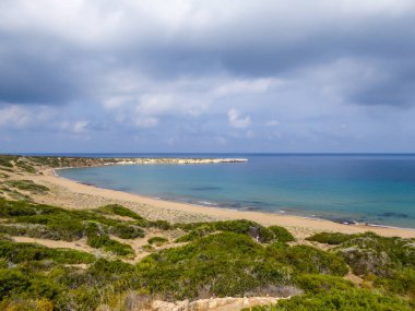 Panoramic view on Lara Beach, Cyprus from above. Hidden gem, not spoiled by tourists. Solitude, calm feelings, waves gently spreading on the beach. turquoise color of the water. Turtle hatching beach