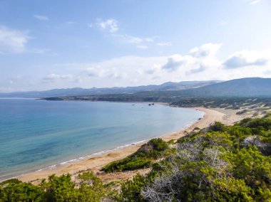 Panoramic view on Lara Beach, Cyprus from above. Hidden gem, not spoiled by tourists. Solitude, calm feelings, waves gently spreading on the beach. turquoise color of the water. Turtle hatching beach
