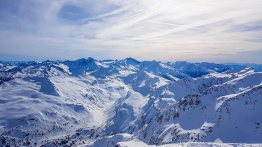 Beautiful and serene landscape of mountains covered with snow in Moelltaler Gletscher, Austria. Thick snow covers the slopes. Clear weather. Perfectly groomed slopes. Massive ski resort. Glacier skiing