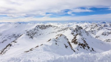 Beautiful and serene landscape of mountains covered with snow in Moelltaler Gletscher, Austria. Thick snow covers the slopes. Clear weather. Perfectly groomed slopes. Massive ski resort. Glacier skiing