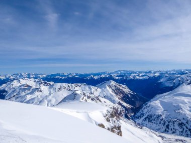 Beautiful and serene landscape of mountains covered with snow in Moelltaler Gletscher, Austria. Thick snow covers the slopes. Clear weather. Perfectly groomed slopes. Massive ski resort. Glacier skiing