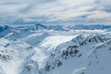 Beautiful and serene landscape of mountains covered with snow in Moelltaler Gletscher, Austria. Thick snow covers the slopes. Clear weather. Perfectly groomed slopes. Massive ski resort. Glacier skiing