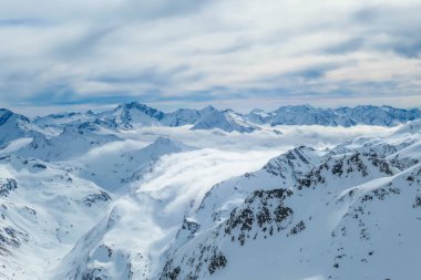 Beautiful and serene landscape of mountains covered with snow in Moelltaler Gletscher, Austria. Thick snow covers the slopes. Clear weather. Perfectly groomed slopes. Massive ski resort. Glacier skiing