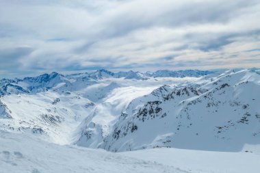 Beautiful and serene landscape of mountains covered with snow in Moelltaler Gletscher, Austria. Thick snow covers the slopes. Clear weather. Perfectly groomed slopes. Massive ski resort. Glacier skiing