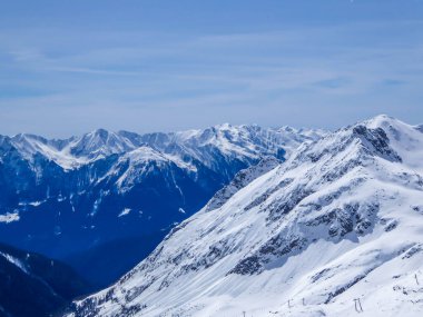 Beautiful and serene landscape of mountains covered with snow in Moelltaler Gletscher, Austria. Thick snow covers the slopes. Clear weather. Perfectly groomed slopes. Massive ski resort. Glacier skiing