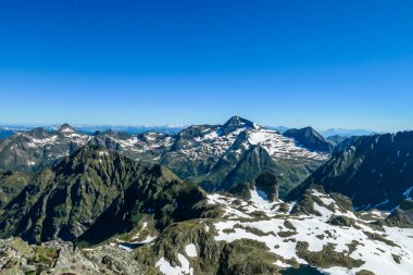 Massive mountain range of Schladming Alps, Austria. The slopes are steep, partially covered with snow. Nature waking up. Dangerous mountain climbing.Clear and beautiful day. Endless mountain ranges