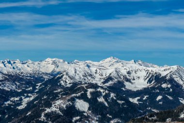 Sunny winter day in the austrian alps in the ski resort of  Bad Kleinkirchheim, Austria. The snow shows a nice reflection. Winter sports in Alpine winter wonderland