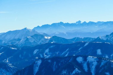 A panorama of a snow caped mountains Alps in Goldeck, Austria. Crispy and frosty morning. The ground is completely covered with snow. Endless mountain chains in the back. Serenity and solitude