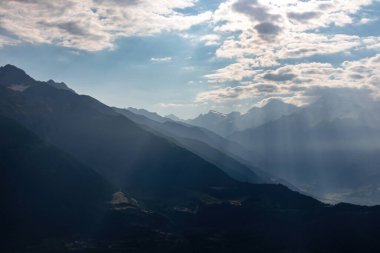 Gürcistan 'ın başkenti Büyük Kafkasya Dağları' ndaki Mestia köyünün muhteşem manzarası. Sabah sisi vadiyi kaplarken, ilk güneş ışınları karlı dağ zirvelerinde beliriyor. Gün doğumu.