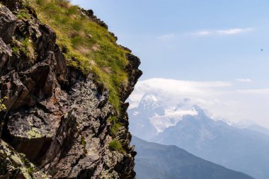 A ledge with an amazing panoramic view on the mountain ridges near Mestia in the Greater Caucasus Mountain Range, Samegrelo-Upper Svaneti, Country of Georgia. Freedom. Wanderlust clipart