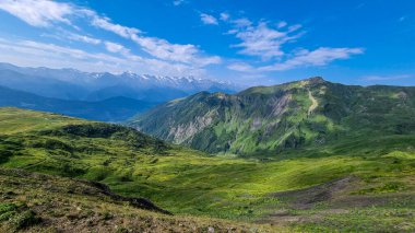 Amazing view on the valley and the surrounding mountain peaks and green hills near Mestia in the Greater Caucasus Mountain Range, Upper Svaneti, Country of Georgia. Hiking trail to the Koruldi Lakes. clipart