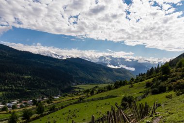 Büyük Kafkasya Dağları 'ndaki Mestia vadisinde inanılmaz bir manzara, Yukarı Svaneti, Gürcistan Ülkesi. Bulutlar karlı dağ zirvelerini kaplıyor. Çit, Özgürlük, Açık Hava, Seyahat