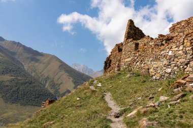 A hiking trail leading to the ruins of the Zakagori fortress in the Truso Valley near the Ketrisi Village Kazbegi District, Mtskheta-Mtianet in the Greater Caucasus Mountains, Georgia.Border to Russia clipart