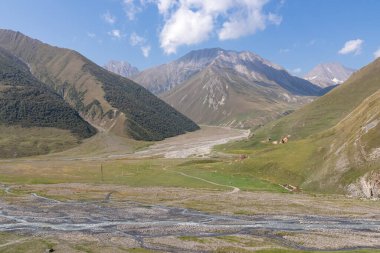 The Terek (Tergi) river flows down the Truso Valley near the Ketrisi Village Kazbegi District,Mtskheta in the Greater Caucasus Mountains,Georgia. View from Zakagori Fortress. Ossetia, Russian border clipart