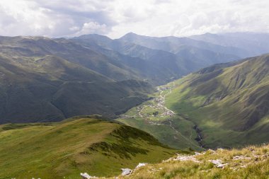 Aerial view on the mountain village Ushguli, near the Shkhara Glacier in the Greater Caucasus Mountain Range in Georgia, Svaneti Region.Chubedishi viewpoint.Patara Enguri River.Svaneti watch towers clipart