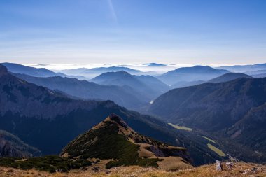 Avusturya 'nın Upper Styria kentindeki Hochschwab Bölgesi' nin dağlık tepelerinde panoramik bir manzara. Alpler 'de güneşli bir yaz gününde bulutsuz bir hava. Mavi sisli vadi ve yumuşak tepeler. Özgürlük kavramı