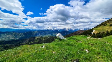 Frauenkogel 'den ilkbaharda Karawanks ve Julian Alps, Carinthia, Avusturya' daki dağ tepelerinde manzaralı bir sınır taşı. Slovenya sınırı. Triglav Ulusal Parkı. Jesenice, Drava Vadisi