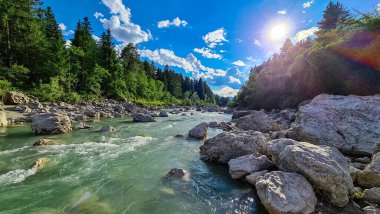 Villach, Carinthia, Avusturya 'daki Dobratsch doğal parkında akan Gail Nehri. Gailtaler ve Alpler. Riverbank kocaman kayalarla dolu. Kristal berrak suda yüzmek