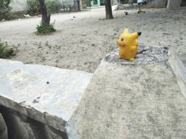 Sıkıcı bir pokemon oyuncağı, küçük, sarı ve siyah karışımı bir şey.