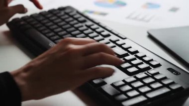 İş kadını ofiste geç saatlere kadar klavyede bilgisayar başında çalışıyor. Finansal raporlar için bilgisayar kullanan, mesai yapan bir kadın.