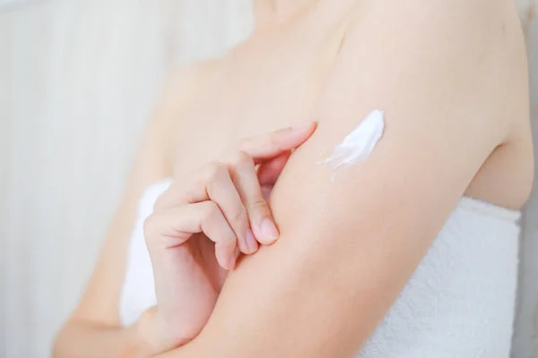 Woman applying natural cream, Woman moisturizing her arm with cosmetic cream, Spa and Manicure concept.