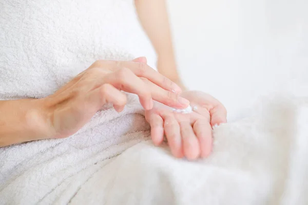Woman applying natural cream, Woman moisturizing her hand with cosmetic cream, Spa and Manicure concept.