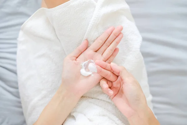 Woman applying natural cream, Woman moisturizing her hand with cosmetic cream, Spa and Manicure concept. Top view