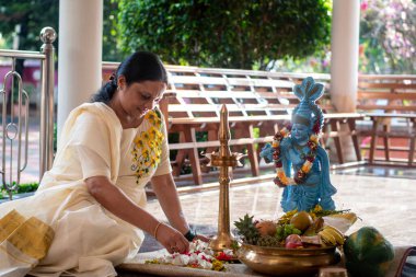 A Picture of middle aged malayali woman making Vishu kani clipart