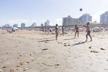 Tourists playing footbal in the beach , in Mar del Plata 