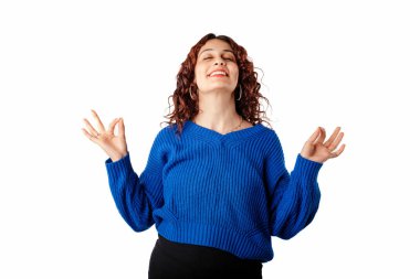 Portrait of young woman standing isolated over white background mudra gesture and poses with eyes closed. People lifestyle concept. Finding tranquility in the present moment.
