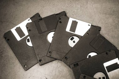 Floppy disks on a gray background clipart