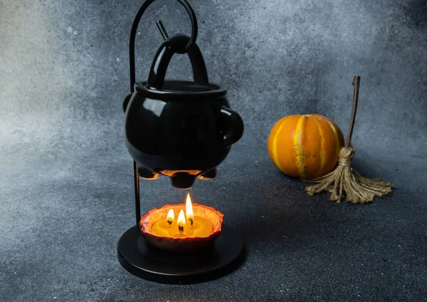 Product photography with cauldron, pumpkin and broom