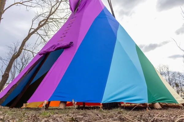 rainbow-coloured tepee set up in the garden, early spring, traditional Indian dwellin