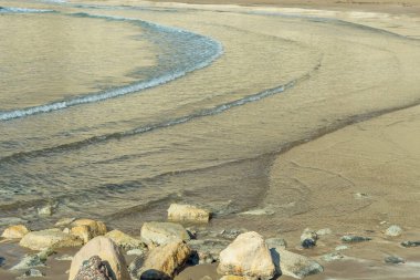 A photo of the surf on Zapallo Bay Beach in Cyprus, with calm sea and sandy beach, conveying an atmosphere of peace and tranquility by the sea clipart