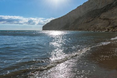 Kıbrıs 'ta bir sahilde denizin yüzeyine yansıyan güneş ışınlarının büyüleyici güzelliğini yakalayın. Suyun kenarında pırıl pırıl ve büyülü bir an yaratın.