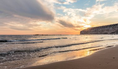 KKKTC sahilinde sıcak gün batımı, denizin üstünde kaya, atmosferik arazi manzarası