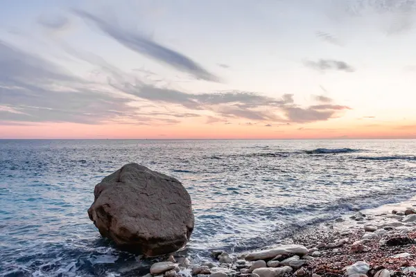 Dramatik uçurumlar, alacakaranlıkta yumuşak dalgalarla karşılaşır. Yalnız bir kaya bekçisi, dayanıklılık, yalnızlık ve doğal güzellik temalarını iletmek için idealdir.