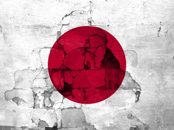 Earthquakes in Japan, flag Japan on a wall with cracks from an earthquake