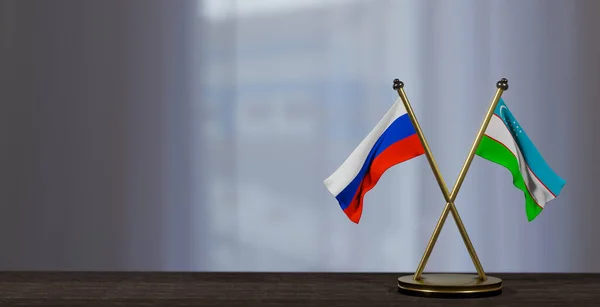 stock image Russia and Uzbekistan flags on table. Negotiation between Uzbekistan and Russia. on little blur background. 3D work and 3D image