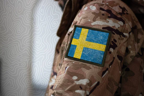 Sweden Soldier. Soldier with flag Sweden, Sweden flag on a military uniform. Camouflage clothing