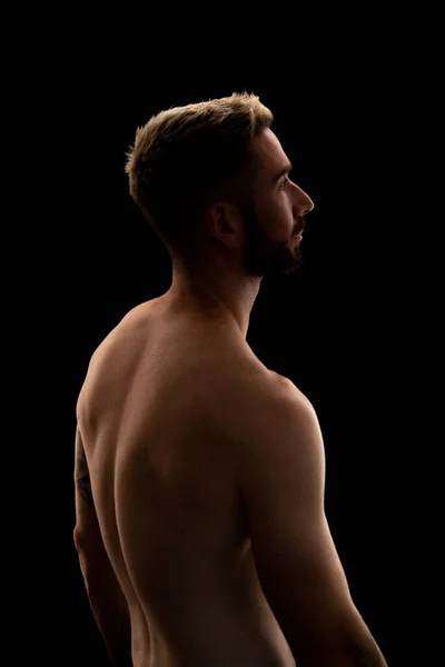 stock image Portrait of a young man with a beard isolated on a black background