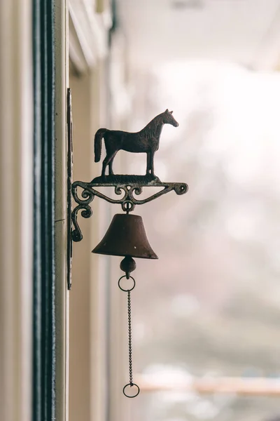 stock image Horse bell hanging on the window. Vintage style. Selective focus.