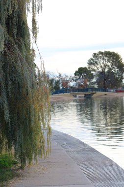Pedestrian walkway in a quiet recreational area of picturesque Cortez park lake in city of  Phoenix, Arizona