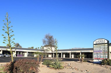 Phoenix, AZ - January 29, 2023:  Business plaza with desert style xeriscaped front yard at Tierra Buena with bakery, house cleaning, church and medical services in North-West Phoenix, Arizona