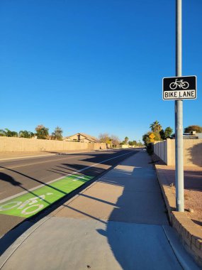 Bright lit by early morning sun road sign for bicyclist to begin their safe ride in a dedicated bike lane