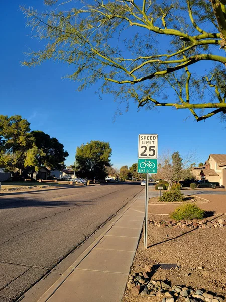 Bright lit by early morning sun road signs for bicyclist and other vehicle in residential area