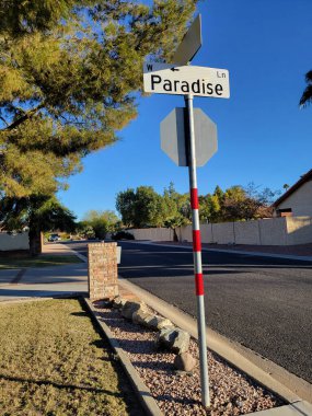 Road sign at a residential city lane with a cute beautiful name of Paradise 