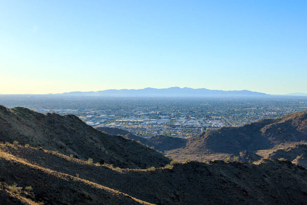 Late afternoon in the west side of Valley of the Sun, view of Glendale, Peoria and Phoenix from North Mountain Park, Arizona, backlit shot; copy space