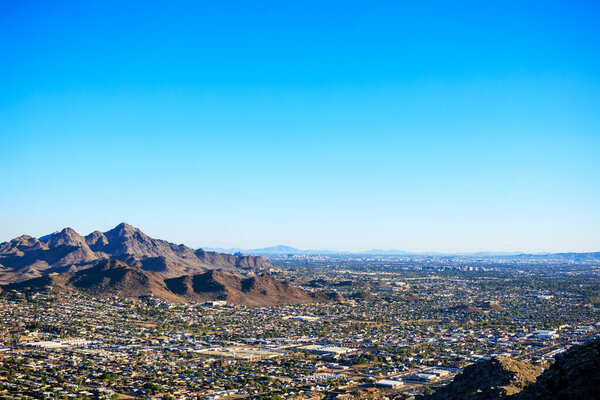 Clear blue cloudless sky over North-East Valley of the Sun as seen from the top of North Mountain Park hiking trails in late afternoon, Phoenix, AZ